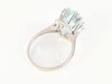 a close up view of a ring with a blue topaz stone