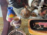 many different vases and bowls on the table