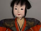 a doll of a woman in a kimono dress