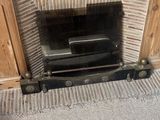 a fire place in the corner of a room with a television on it