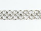 silver metal chain bracelet with rings and beads on a white surface