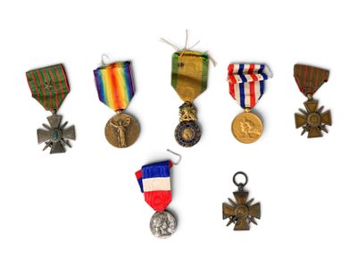 an assortment of medals and medals are displayed on a white surface