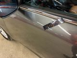 a car with a sticker on the side of it ' s door