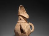 a close up of a clay figurine of a man with a hat on his head