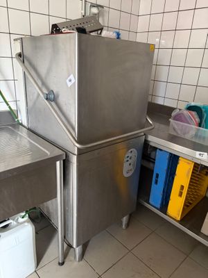 un évier en acier inoxydable dans une cuisine, à côté d'un meuble métallique