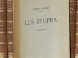 un livre posé sur une étagère à côté d'une pile de livres