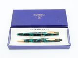 two pens in a box with a blue box on a white background