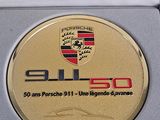 porsche 911 50th commemorative coin in presentation box on white surface
