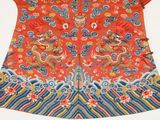 an orange and blue dress with a dragon design on it