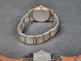 two watches that are sitting on a table