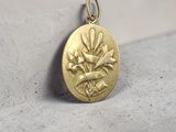 a close up of a gold locke with a flower on it