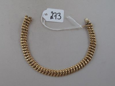 a close up of a gold bracelet with a price tag on it
