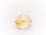 a close up of a yellow diamond on a white background