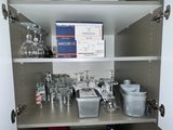 a cabinet with a lot of glassware on it