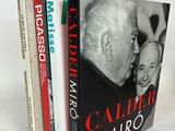 two books are stacked on top of each other on a white surface