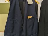 two jackets that are hanging on a rack in a store