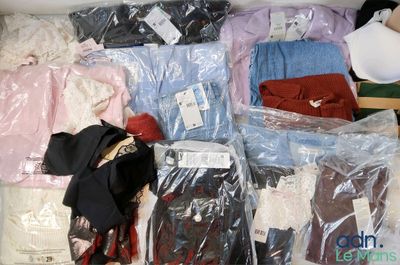 a lot of clothes in a box on the floor