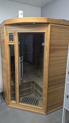 a wooden sauna in the corner of a room