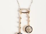 a close up of a necklace with a musical note on it
