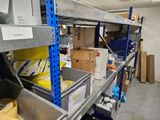 many boxes and containers on the shelves in the room
