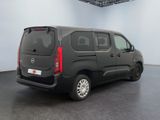 the black van is parked in the large room of the building