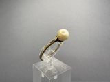 an image of a ring with a pearl on it