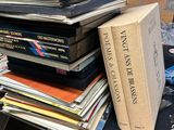 many books stacked on top of each other on a table