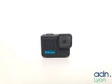 an action camera sitting on top of a white surface