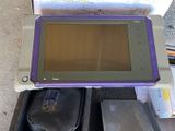 a purple and gray tablet computer sitting on a table