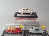 three different models of cars are on display in a display case