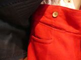 a close up of a person holding a red purse