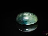 a picture of a green stone on a black surface