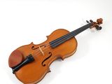 an old violin on a white surface with a white background