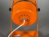 an orange table lamp with a white cord attached to it