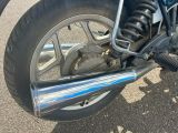 a close up of a motorcycle parked on the street