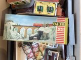 a cardboard box filled with assorted toys and other items