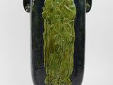 a green vase with a picture of a woman on it