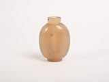 a small brown vase sitting on a white surface