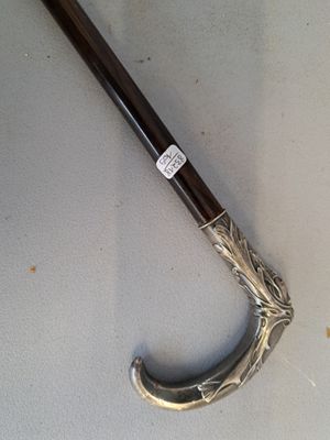 a silver and black umbrella on a white surface