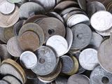 a pile of old coins sitting on a table