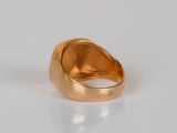 an image of a gold ring sitting on top of a white surface