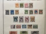 an old picture of a collection of stamps on display in a frame