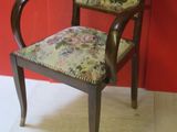 a wooden chair with a floral upholstered seat