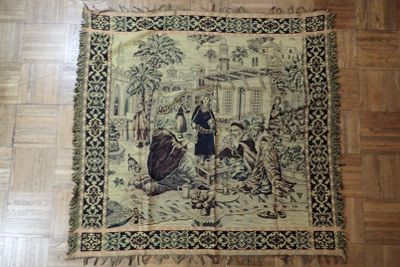 a tapestry on the floor of a room with a picture of a woman and two children