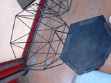 a black tray sitting on the floor next to a red door