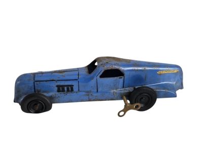 une petite voiture bleue posée sur une surface blanche