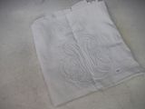 a piece of white cloth with a monogram on it