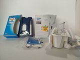 a box of toothpaste and a cup of toothpaste next to a toothbrush