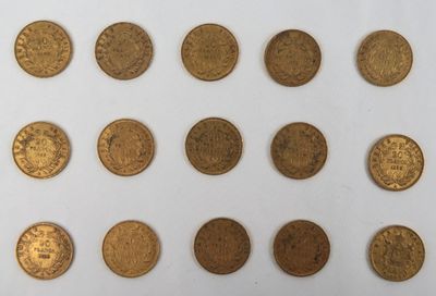 a close up of a bunch of gold coins on a white surface