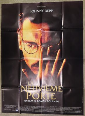 a movie poster of a man with glasses holding a cigarette